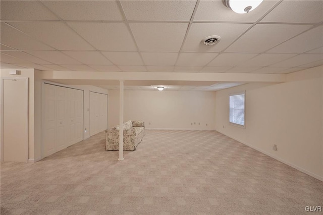 basement featuring carpet and a drop ceiling