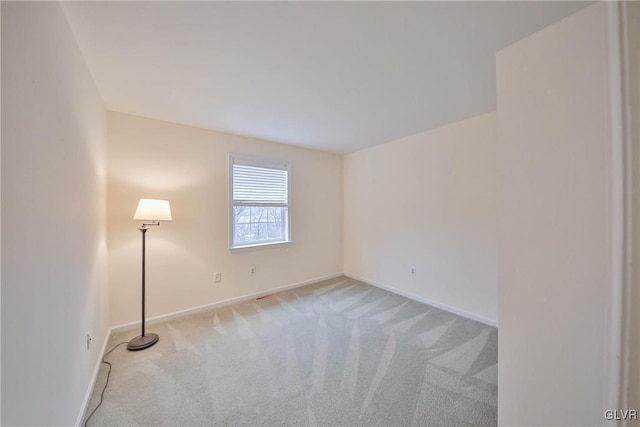 spare room with light colored carpet