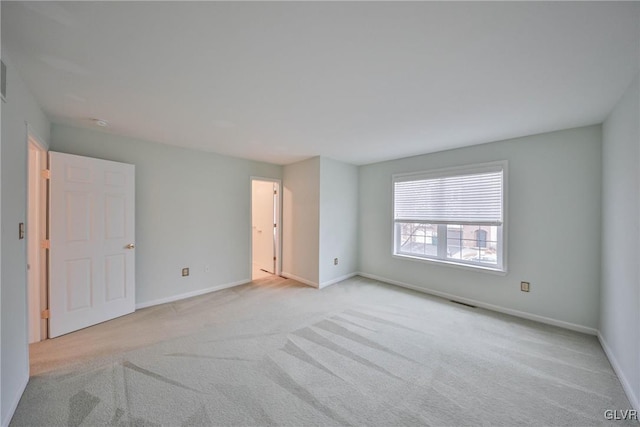 unfurnished room with light colored carpet