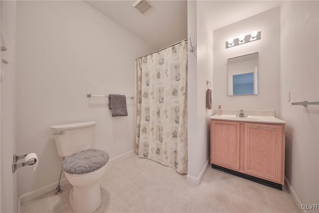 bathroom with walk in shower, vanity, and toilet