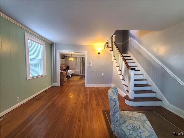 staircase with radiator and hardwood / wood-style floors