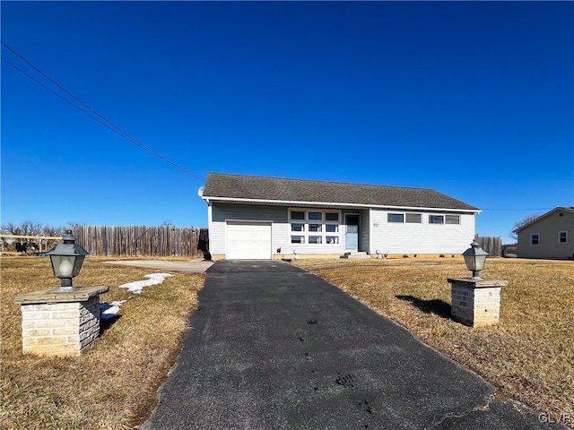 view of front facade with a garage and a front yard