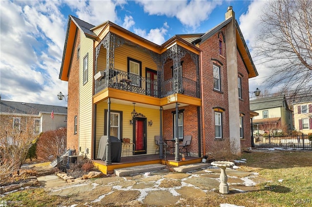 view of front facade featuring covered porch and a balcony