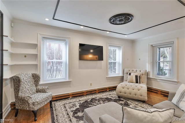 sitting room featuring hardwood / wood-style flooring and crown molding