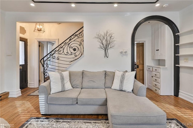 living room with ornamental molding and hardwood / wood-style floors