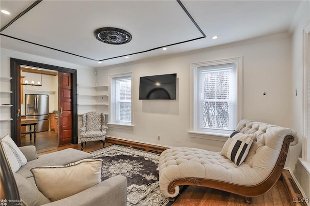 living room with crown molding and hardwood / wood-style floors