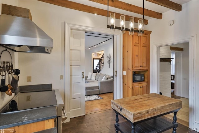 kitchen with dark hardwood / wood-style flooring, island range hood, beam ceiling, and decorative light fixtures