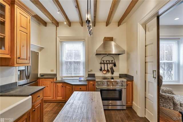 kitchen featuring exhaust hood, appliances with stainless steel finishes, sink, and beam ceiling