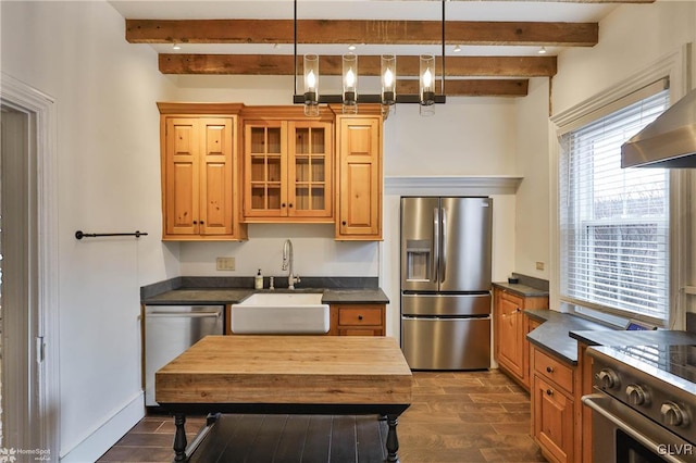 kitchen featuring hanging light fixtures, appliances with stainless steel finishes, sink, and beam ceiling