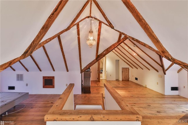 bonus room featuring vaulted ceiling with beams and wood-type flooring