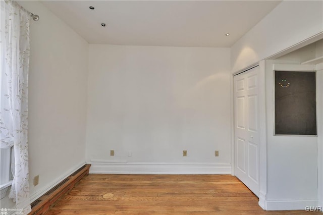 unfurnished room with light hardwood / wood-style floors