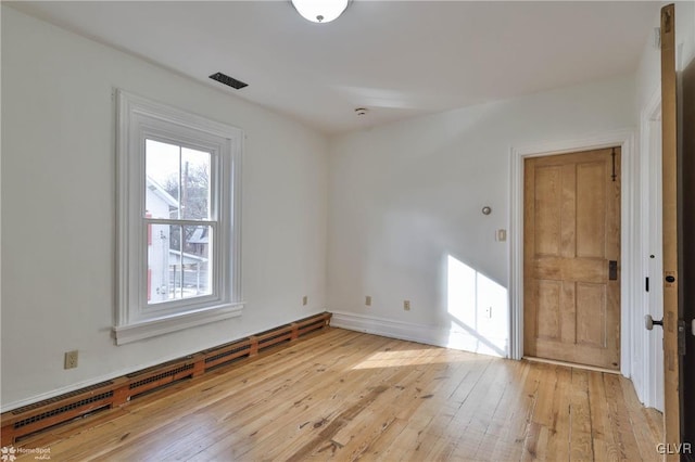 unfurnished room with light hardwood / wood-style flooring