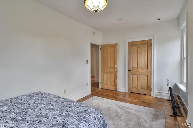 bedroom with hardwood / wood-style floors