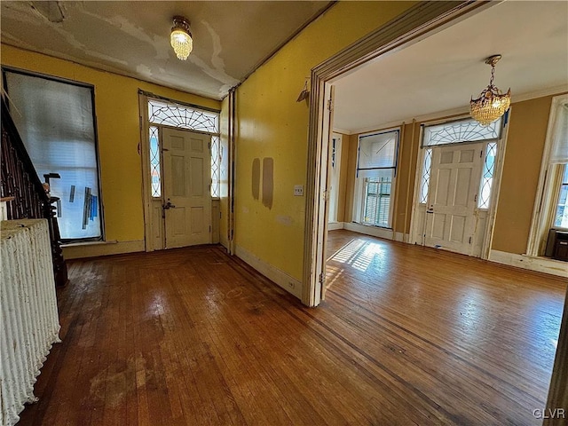 foyer entrance featuring dark hardwood / wood-style flooring and ornamental molding