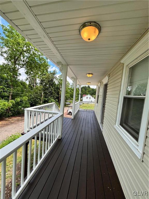 wooden terrace with a porch