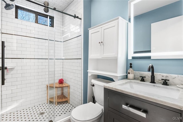 bathroom featuring vanity, an enclosed shower, and toilet