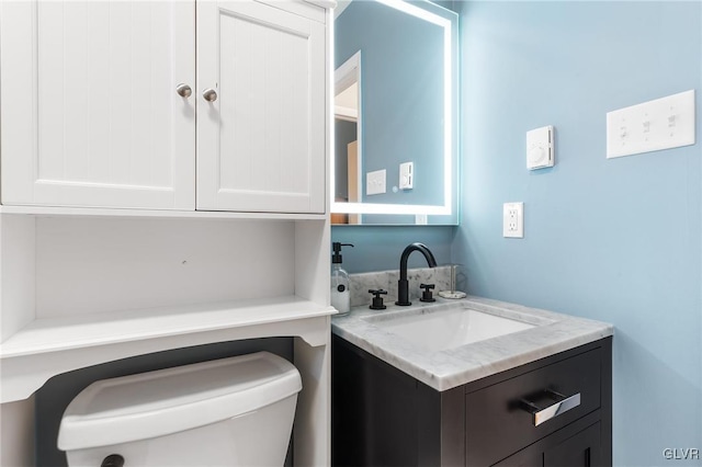 bathroom with vanity and toilet