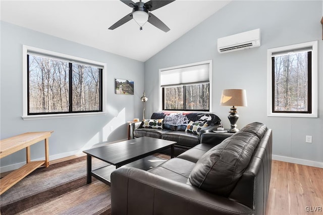 living room with lofted ceiling, a wall mounted air conditioner, hardwood / wood-style floors, and ceiling fan