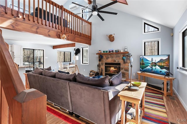 living room with high vaulted ceiling, a fireplace, light hardwood / wood-style floors, and ceiling fan