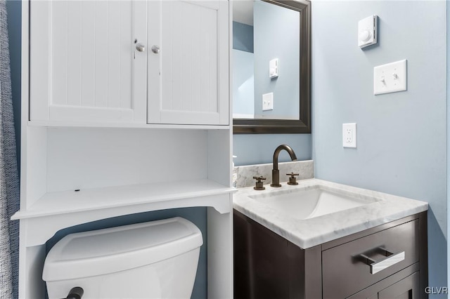 bathroom featuring vanity and toilet