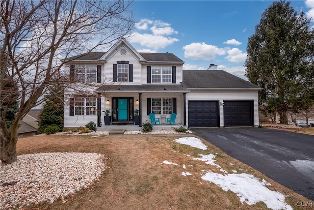 front of property with a garage and a porch