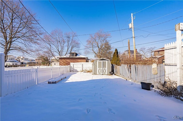 yard covered in snow with a storage unit