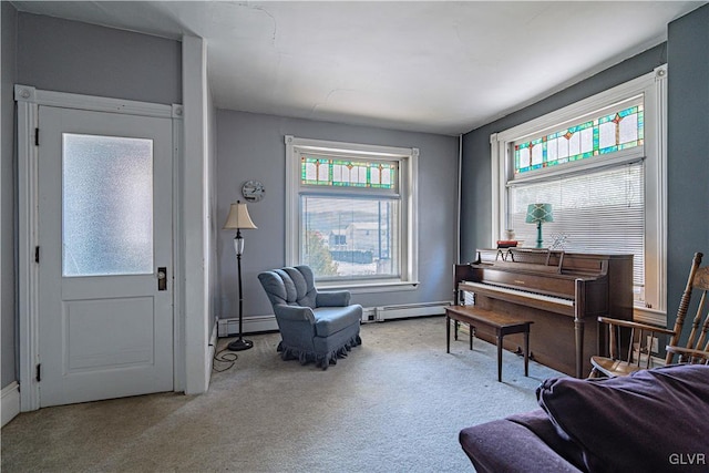 sitting room featuring a baseboard radiator and light carpet