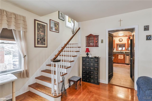 stairway featuring sink and wood-type flooring