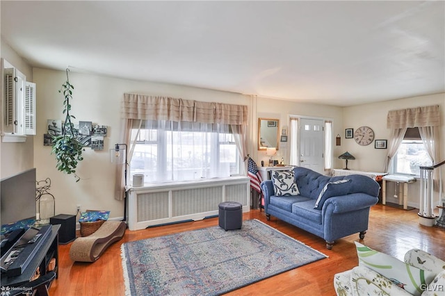 living room with hardwood / wood-style flooring and radiator heating unit