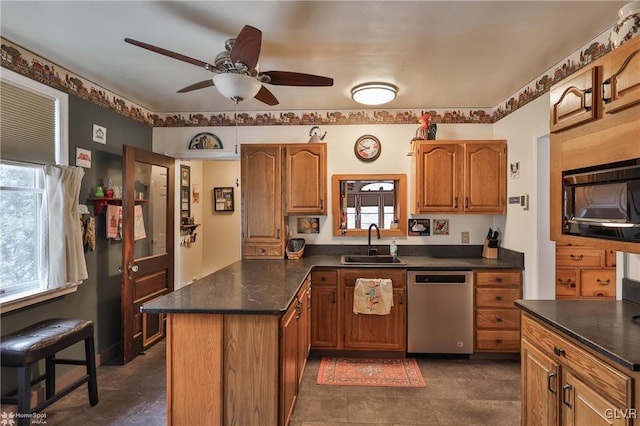 kitchen featuring black microwave, sink, stainless steel dishwasher, and ceiling fan