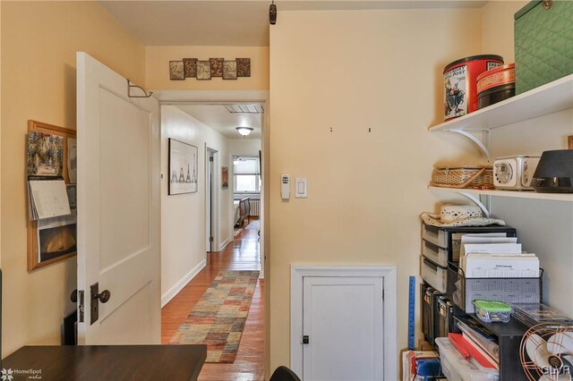 corridor with wood-type flooring