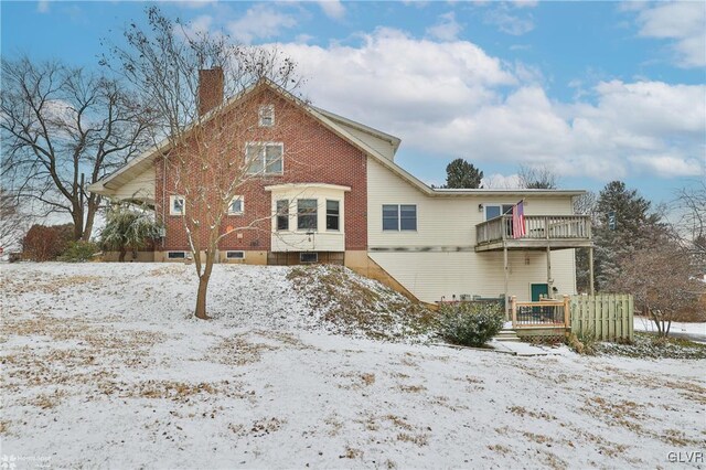 snow covered property featuring a balcony