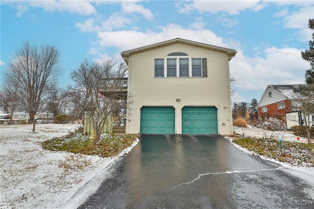 view of snowy exterior with a garage