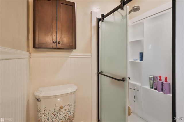 bathroom featuring a shower with shower door