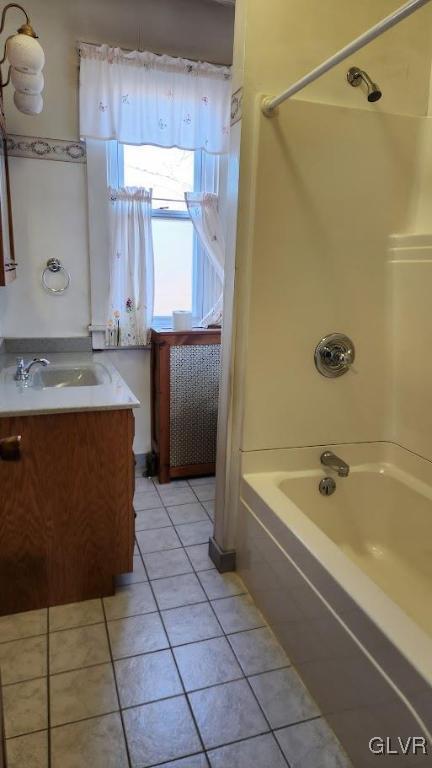 bathroom with tile patterned flooring, vanity, and shower / bath combination