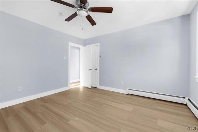 unfurnished room with a baseboard heating unit, light hardwood / wood-style flooring, and ceiling fan