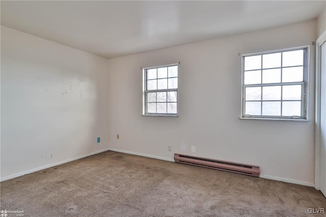 carpeted spare room featuring a baseboard radiator