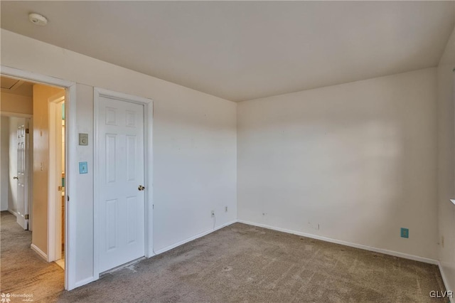 unfurnished room featuring light colored carpet