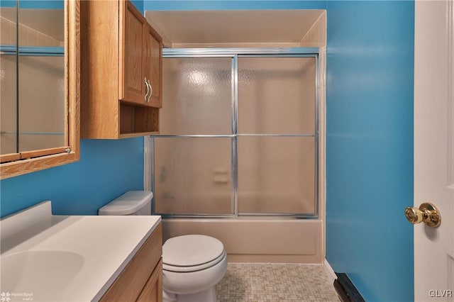 full bathroom featuring enclosed tub / shower combo, vanity, and toilet