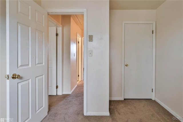 hall with light colored carpet