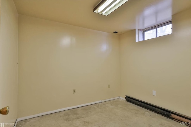 spare room featuring a baseboard heating unit