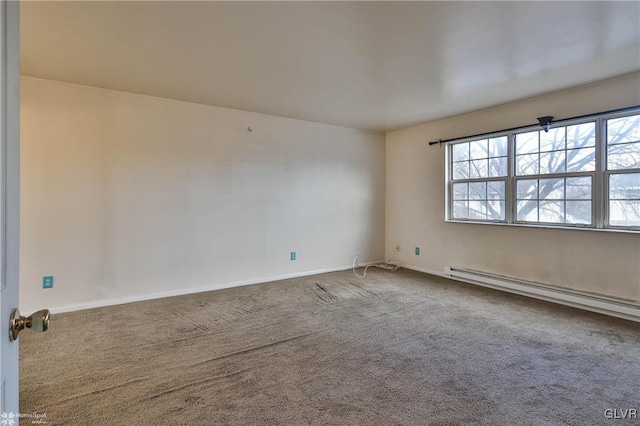 carpeted empty room with a baseboard radiator