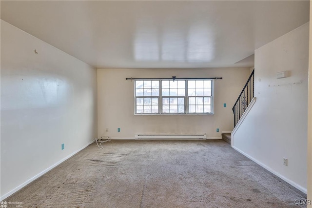 empty room featuring a baseboard radiator and light colored carpet