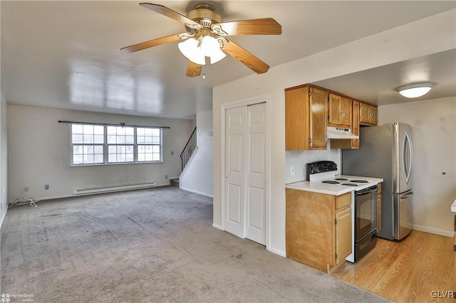 kitchen with electric range, baseboard heating, ceiling fan, stainless steel fridge, and light colored carpet