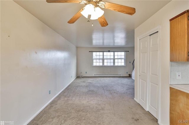 carpeted empty room with baseboard heating