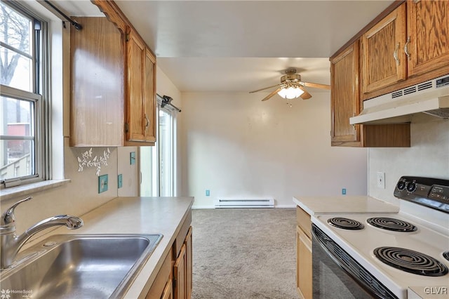 kitchen featuring a baseboard radiator, sink, a healthy amount of sunlight, light carpet, and electric stove