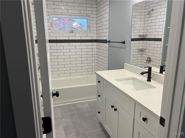 bathroom with vanity and tiled shower / bath combo