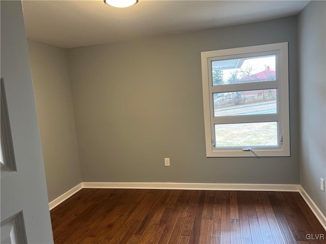 spare room with dark hardwood / wood-style flooring