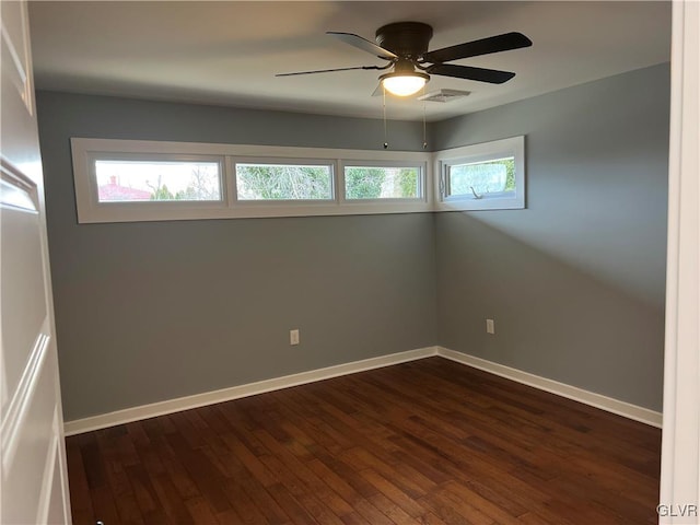 unfurnished room featuring dark hardwood / wood-style floors and ceiling fan