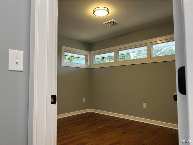 spare room with dark hardwood / wood-style floors